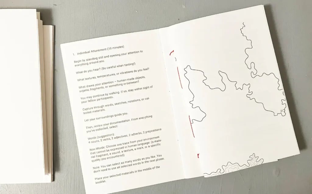 An open workshop booklet lies on a gray surface, showing printed instructions for &ldquo;Individual Attunement&rdquo; on the left page and abstract contour lines on the right.
