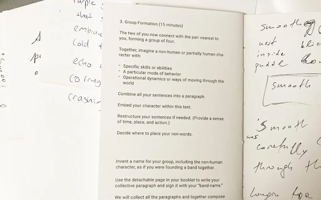 An open workshop booklet shows printed text with group instructions on the left page and handwritten words and notes on the right page