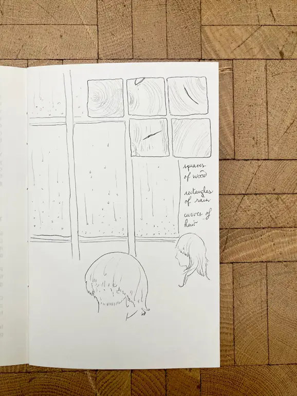 A sketch on white paper combines several fragments, including drawings of two heads, small squares with wood grain patterns, and handwritten words.