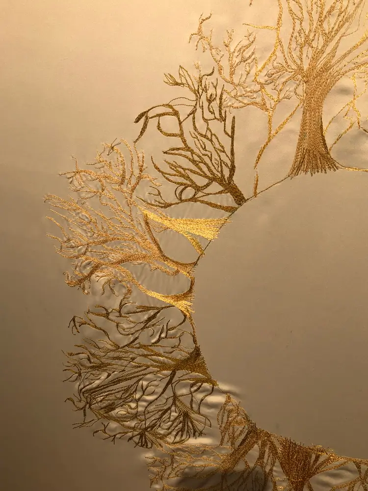 a gold root or tree like embroidery