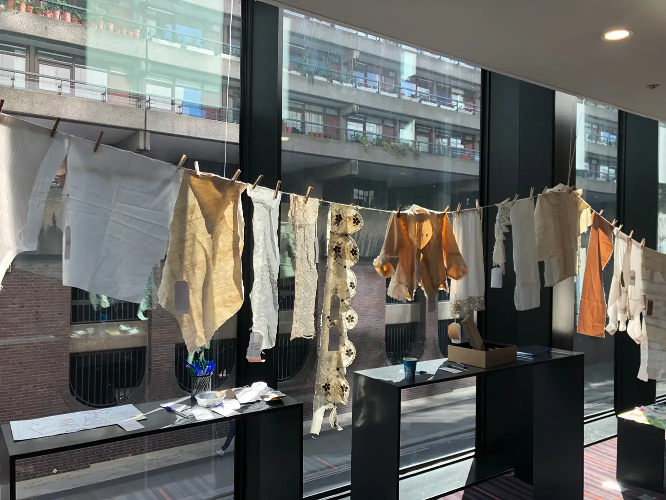 a washing line of clothes and materials in cream and white